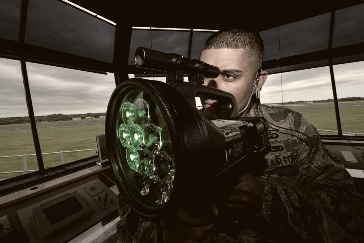 Air traffic controller using a signal light gun in the control tower